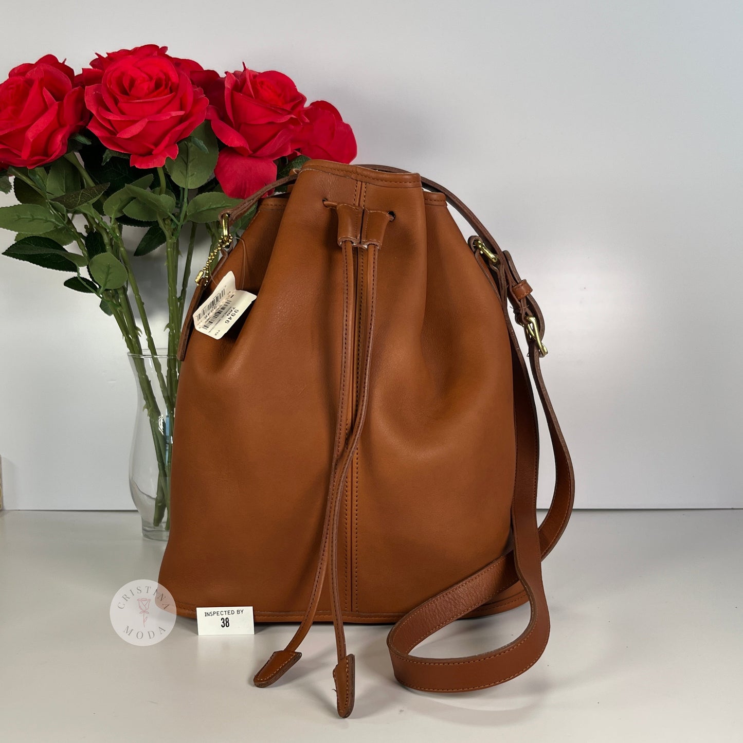 Photo of front of Nicholas Drawstring Bag with vase of roses in background