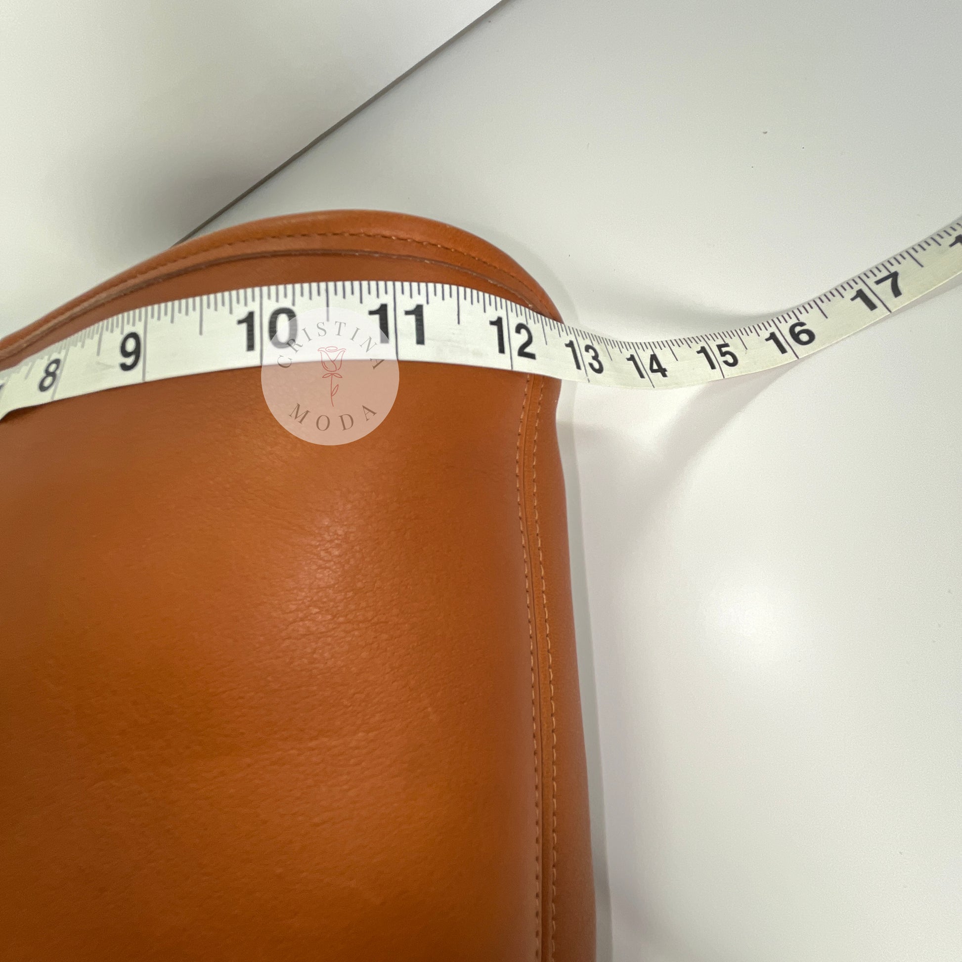 Close-up photo showing measuring tape measuring the front width of the bag. 