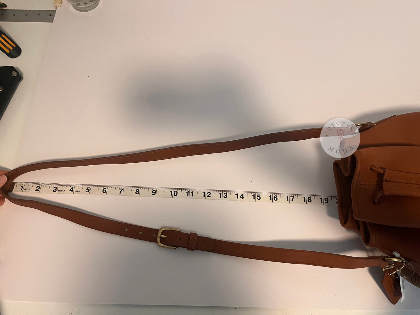 Photo showing measuring tape measuring the strap drop of the bag. 