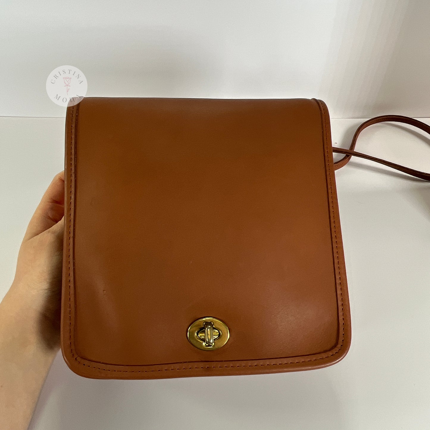 Up close photo of front of vintage coach compact pouch