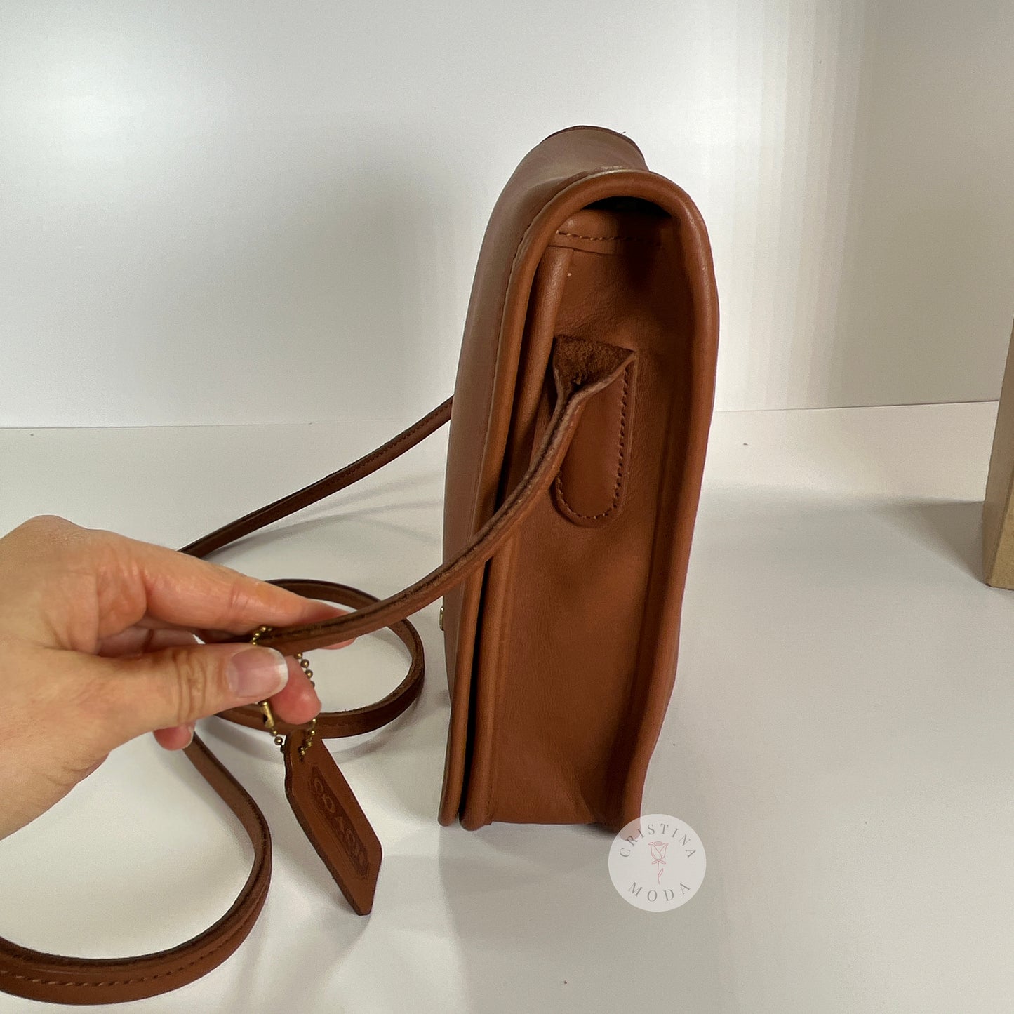 Side view of vintage coach compact pouch