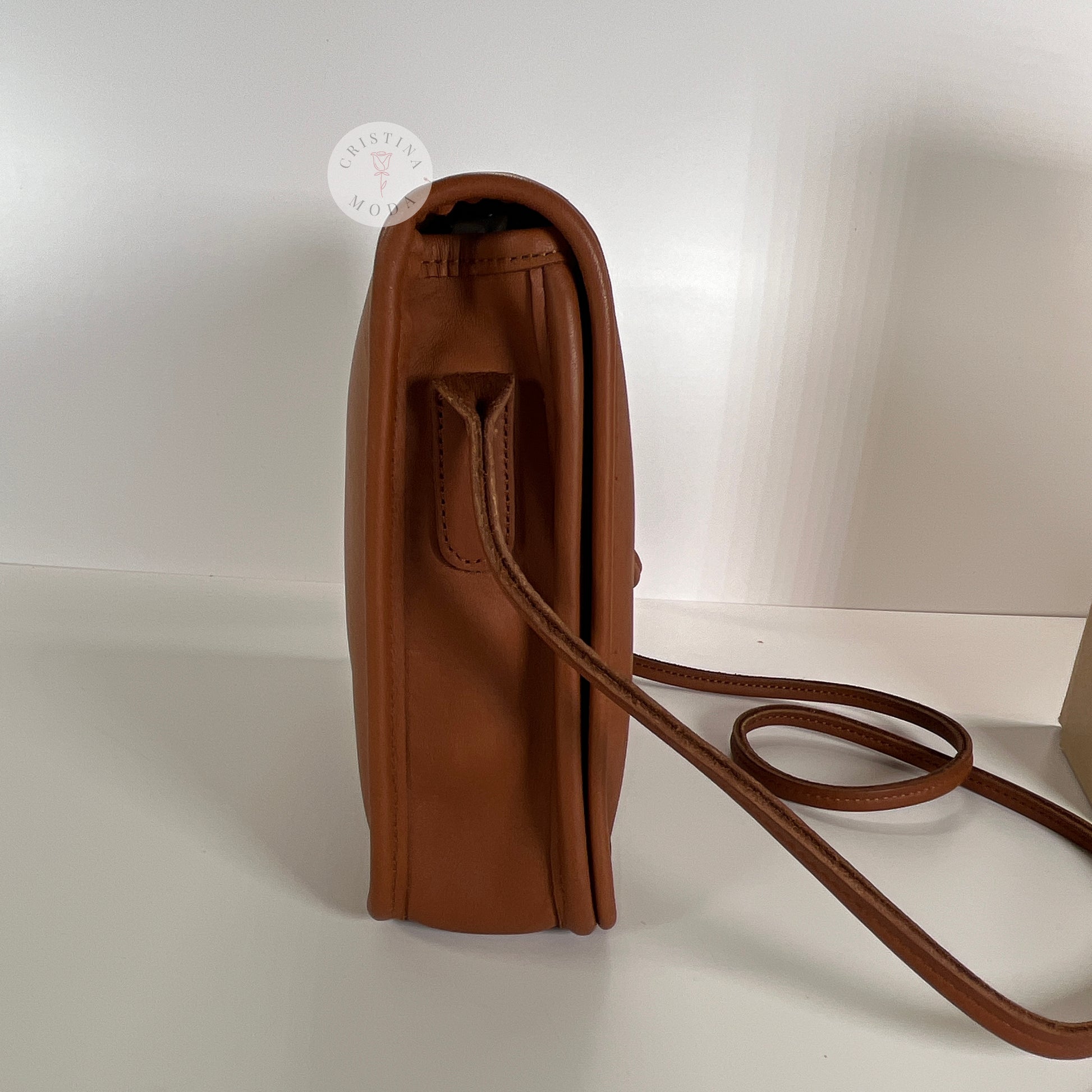 Side view of vintage coach compact pouch