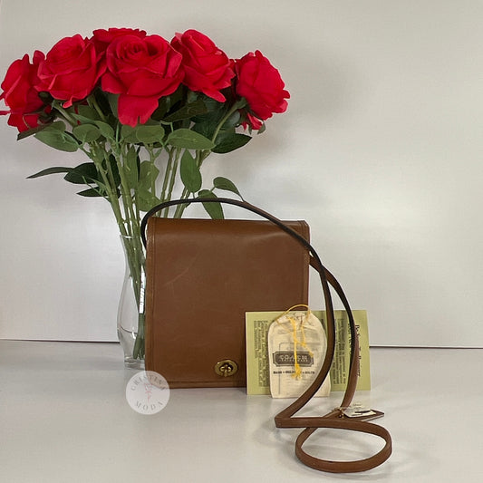 Photo of front of bag in front of vase of roses