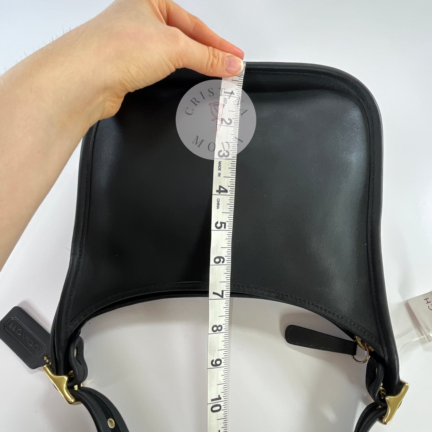 Photo showing measuring tape measuring height of bag