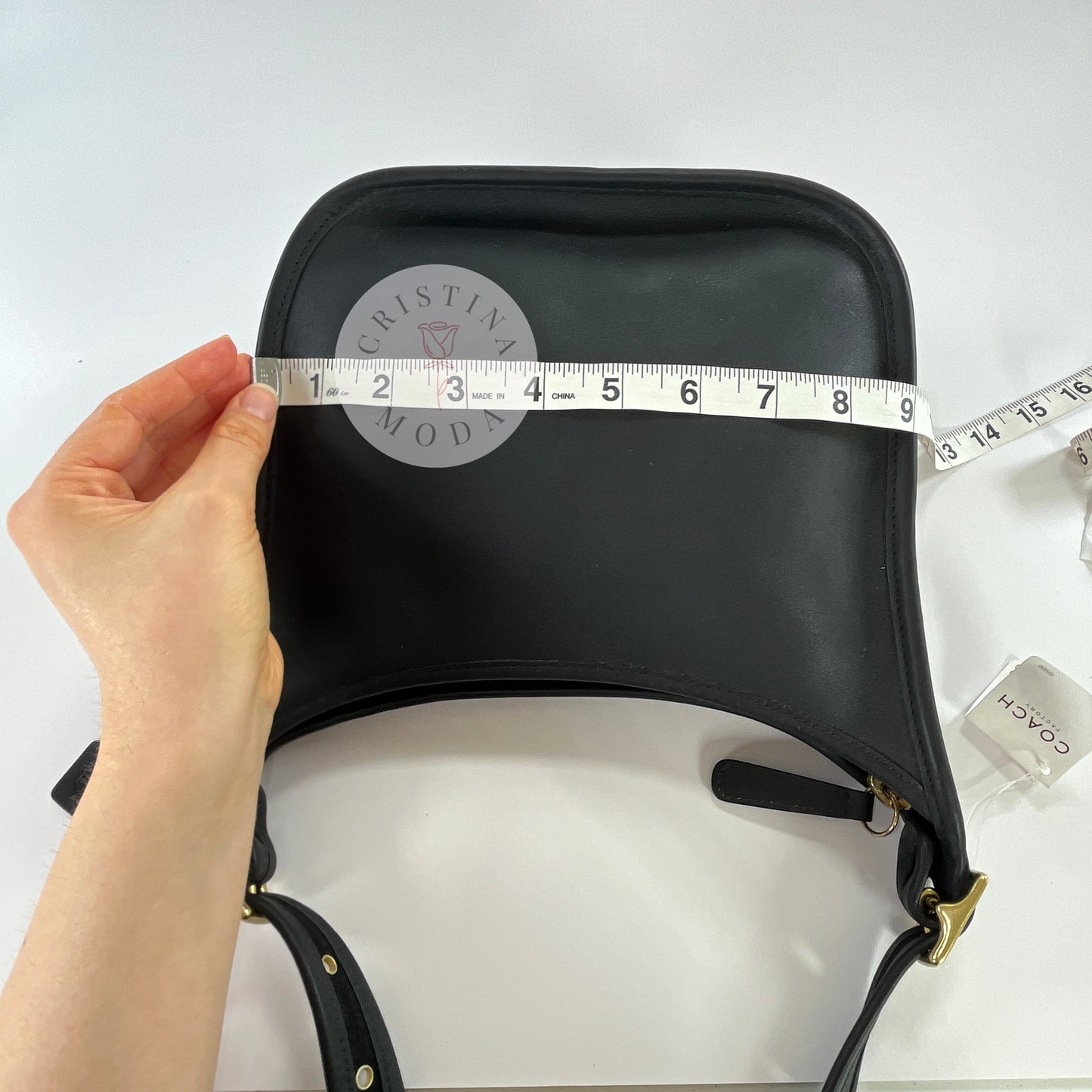 Photo showing measuring tape measuring width of bag