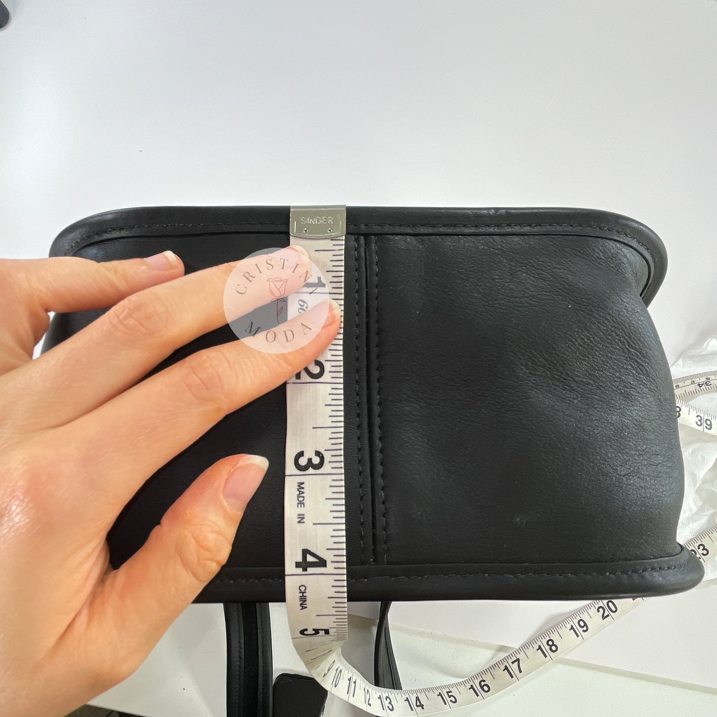 Photo showing measuring tape measuring depth of bag
