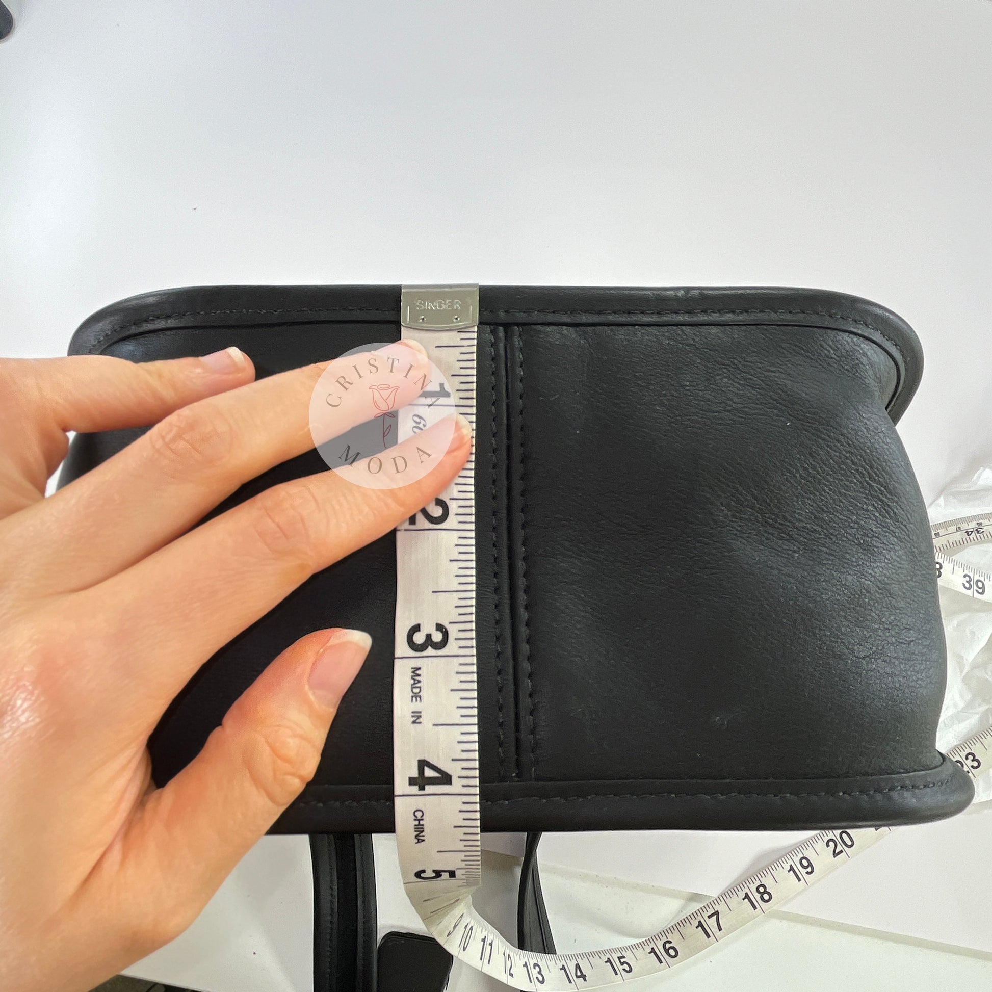 Photo showing measuring tape measuring depth of bag