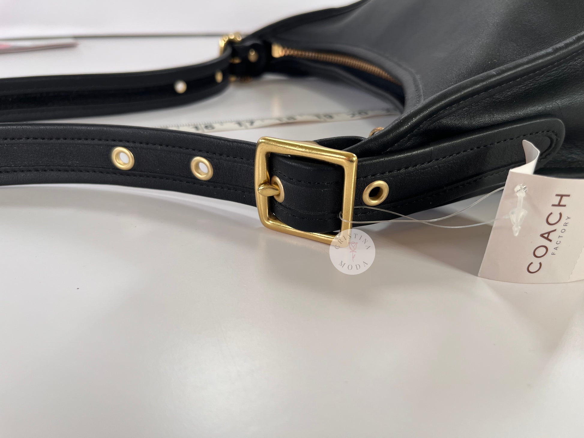 Close up photo showing the shoulder strap, showing which buckle setting the bag was on when strap drop measurements were taken
