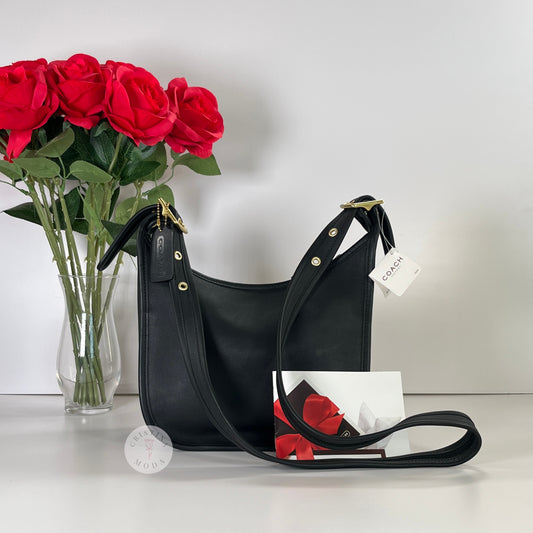Cover photo of vintage coach janice's legacy bag with bag in front of a vase of roses