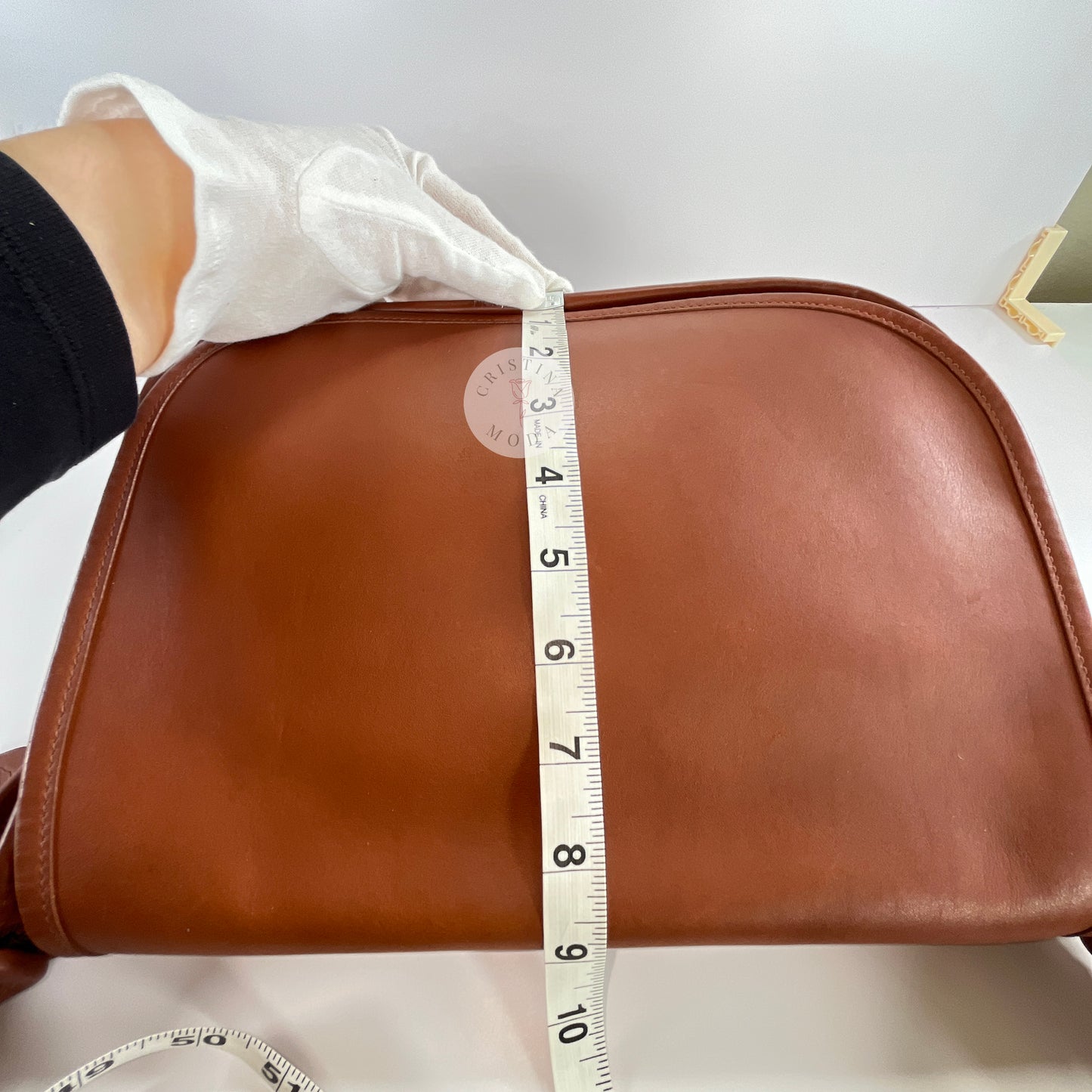 View of measuring tape showing height measurement of vintage coach Patricia's Legacy Bag in British Tan
