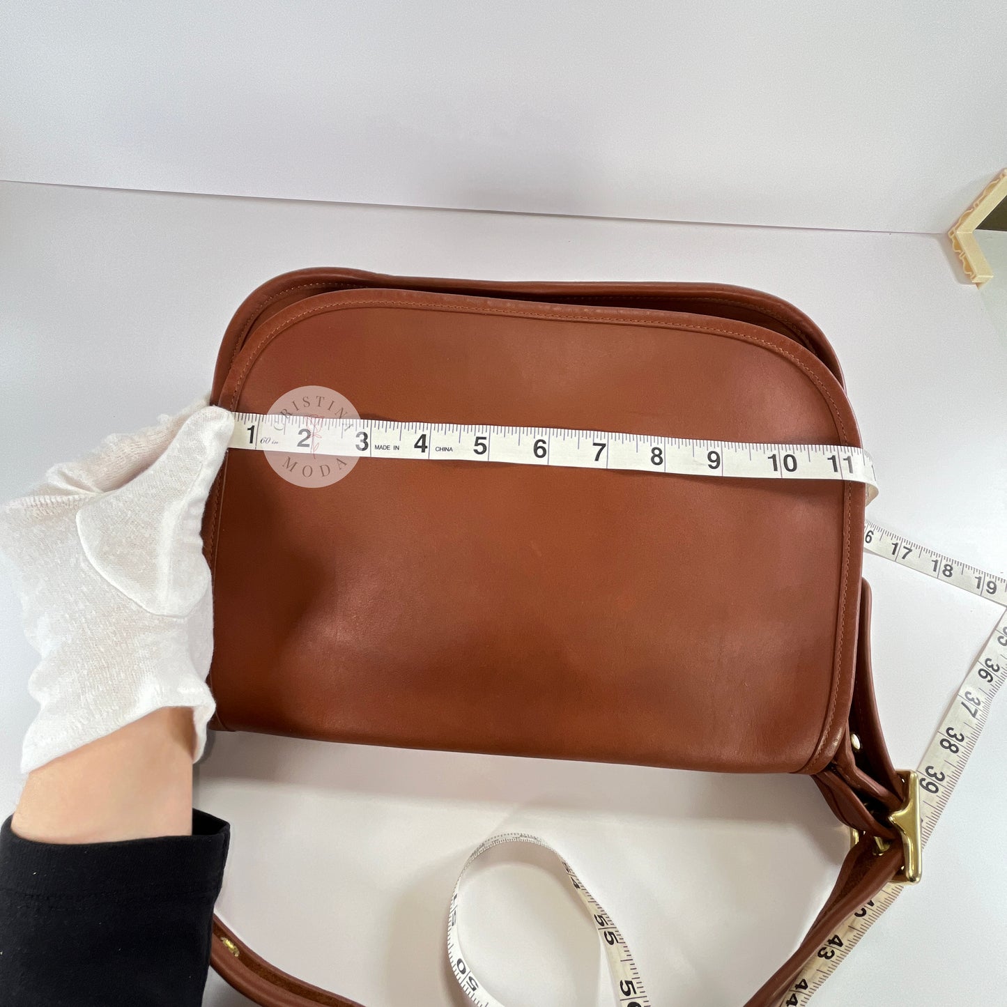 View of measuring tape showing width measurement of vintage coach Patricia's Legacy Bag in British Tan