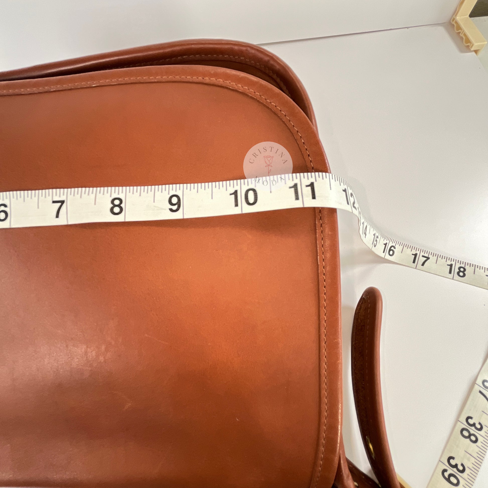 Close up view of measuring tape showing width measurement of vintage coach Patricia's Legacy Bag in British Tan