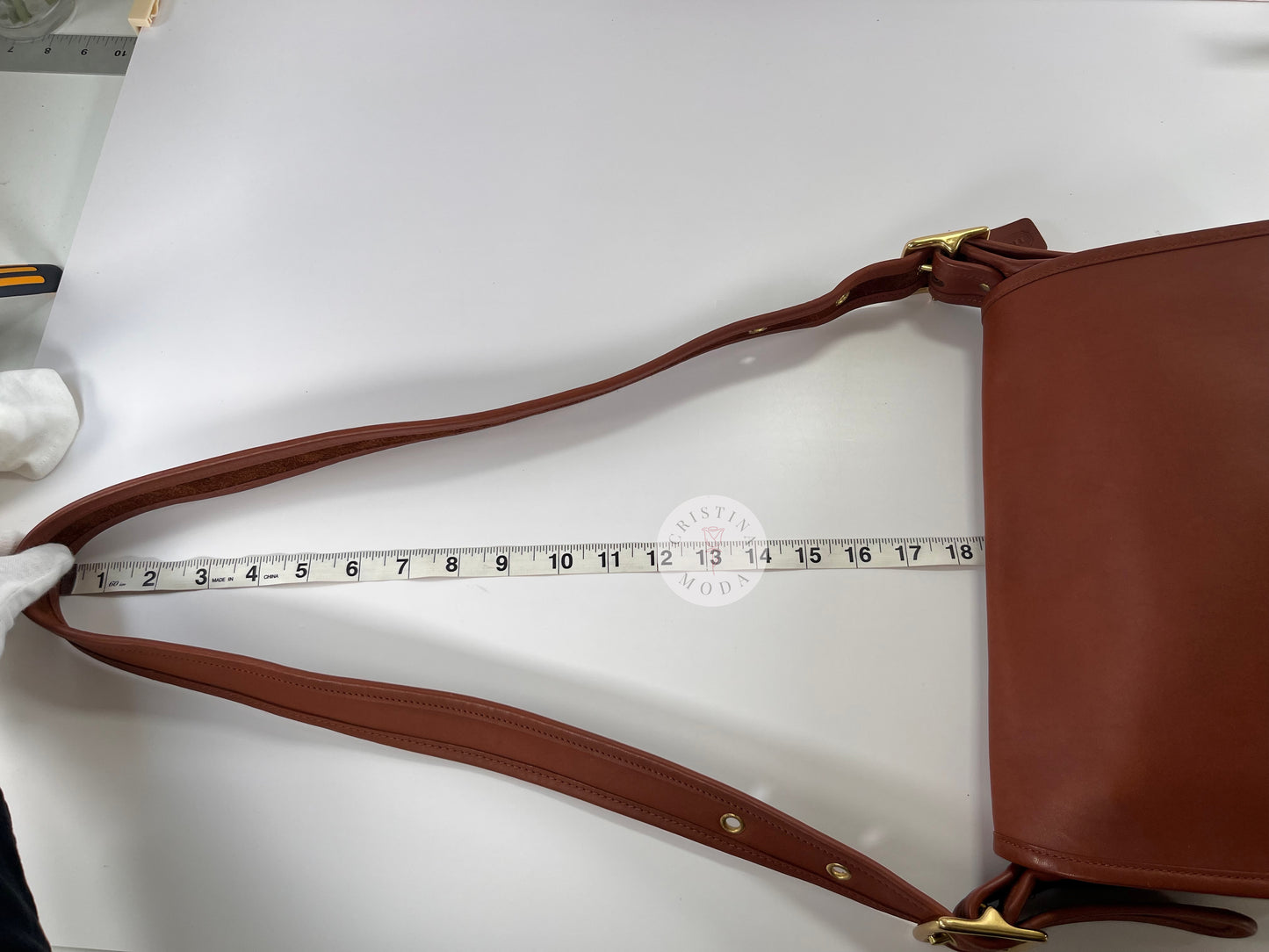 View of measuring tape showing strap drop measurement of vintage coach Patricia's Legacy Bag in British Tan
