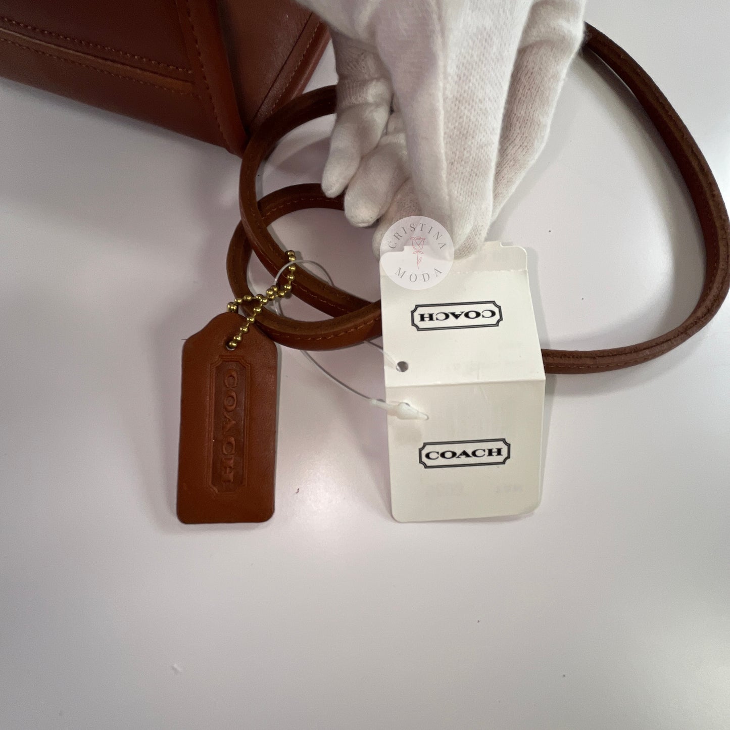 View of the price tag attached to British Tan vintage Coach Scooter Bag.