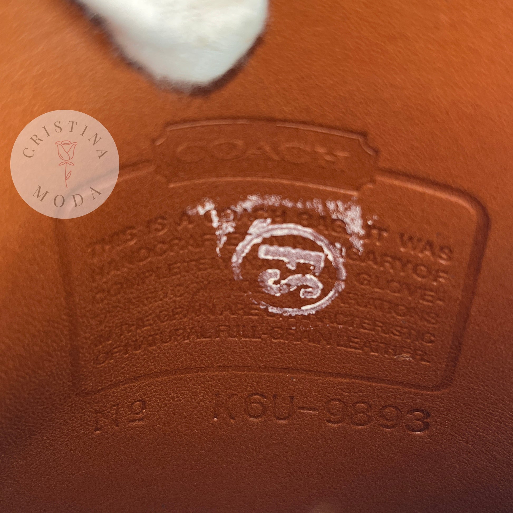 View of the Coach creed inside of the British Tan vintage Coach Scooter Bag.