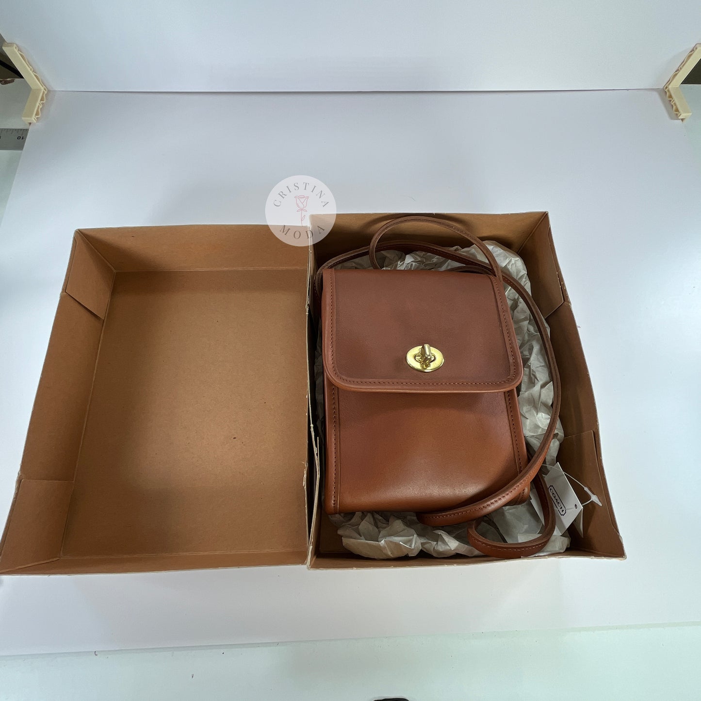 View of British Tan vintage Coach Scooter Bag inside of the box it comes with