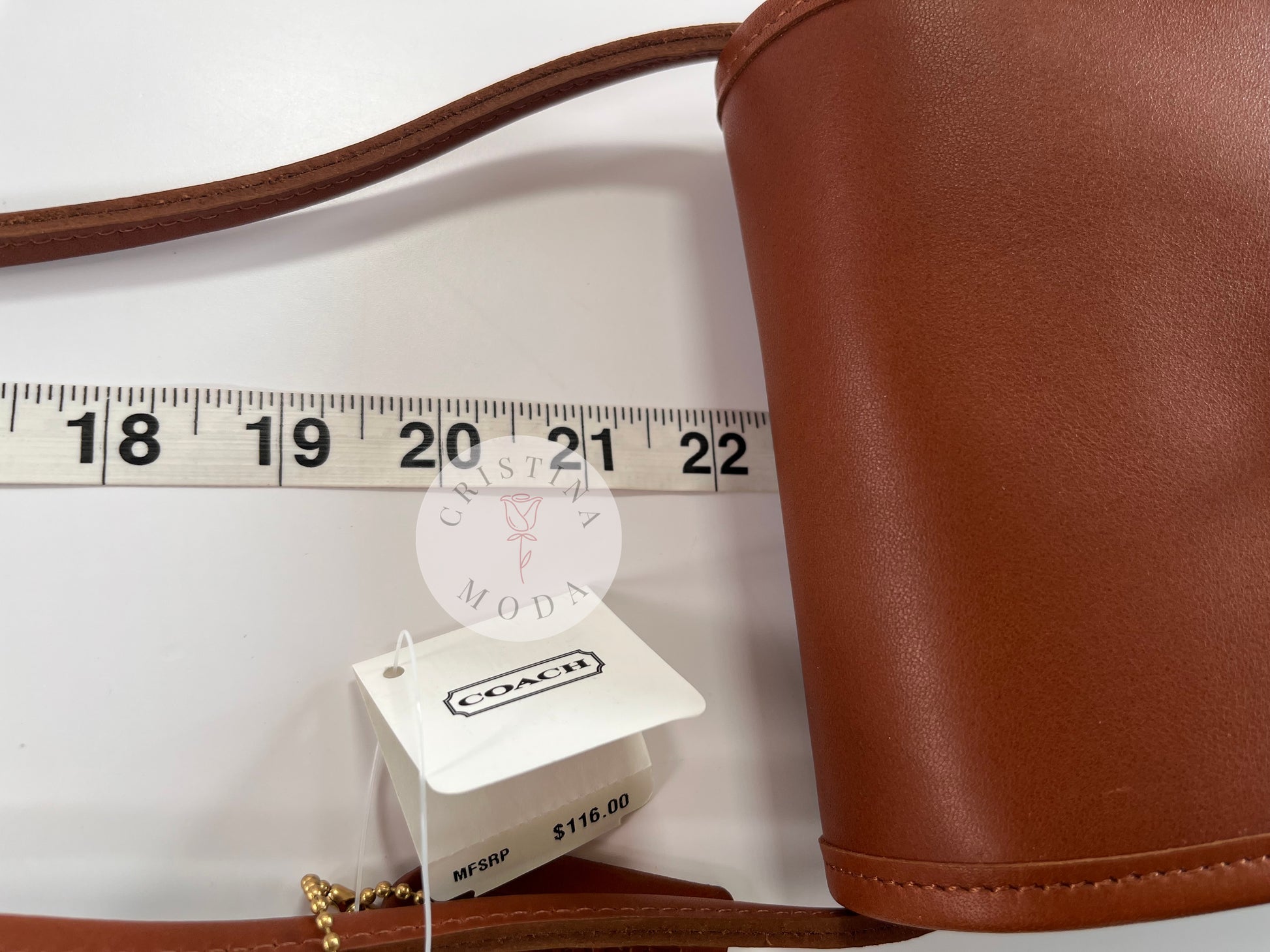 View of British tan vintage Coach Scooter Bag with tape measure showing close up of strap drop measurement