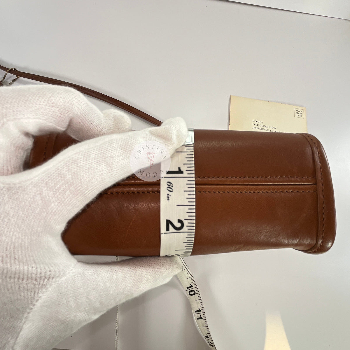 Vintage Coach Scooter bag in British Tan leather with measuring tape showing depth measurement