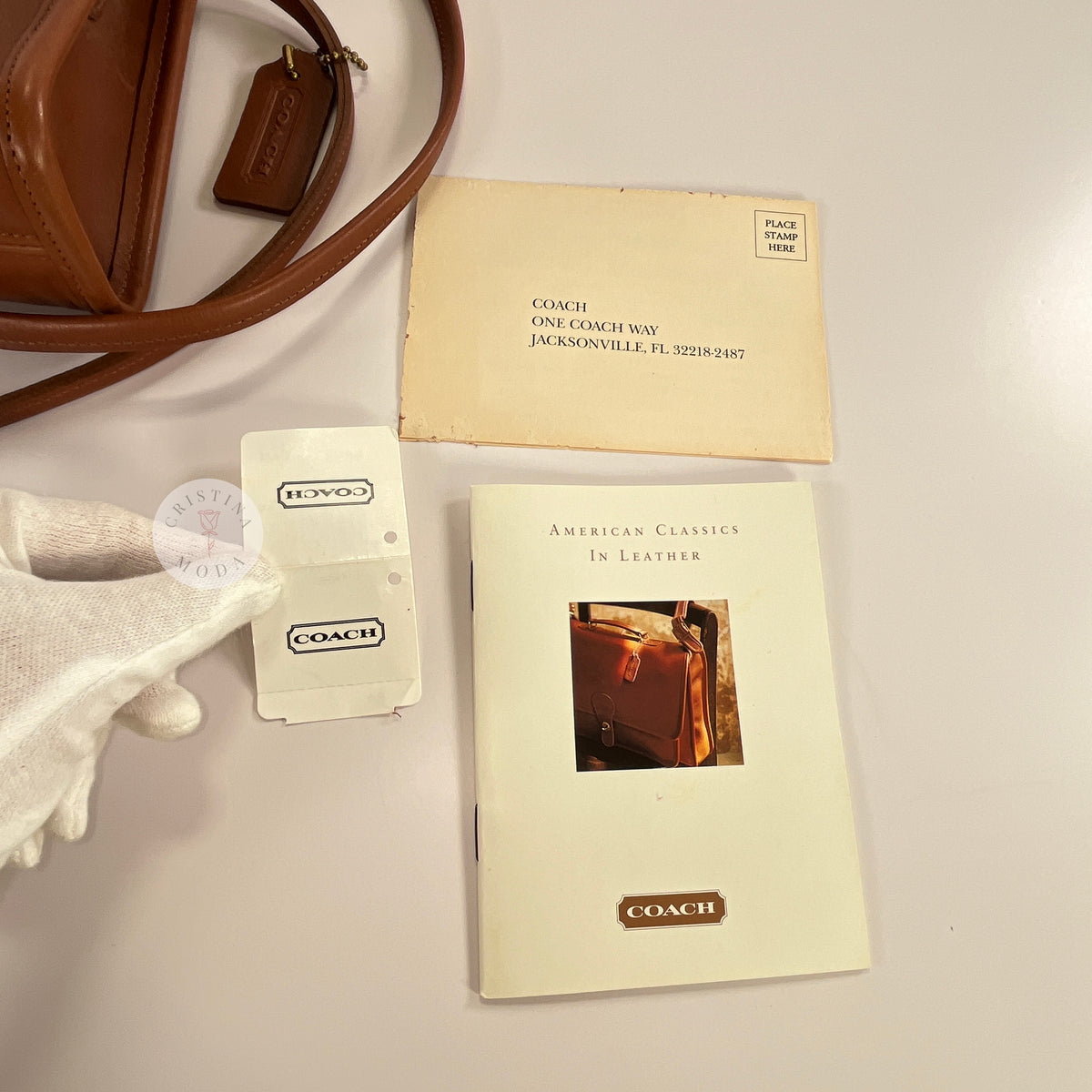 Vintage Coach Scooter bag in British Tan leather, view of price tag, booklet, and registration card 