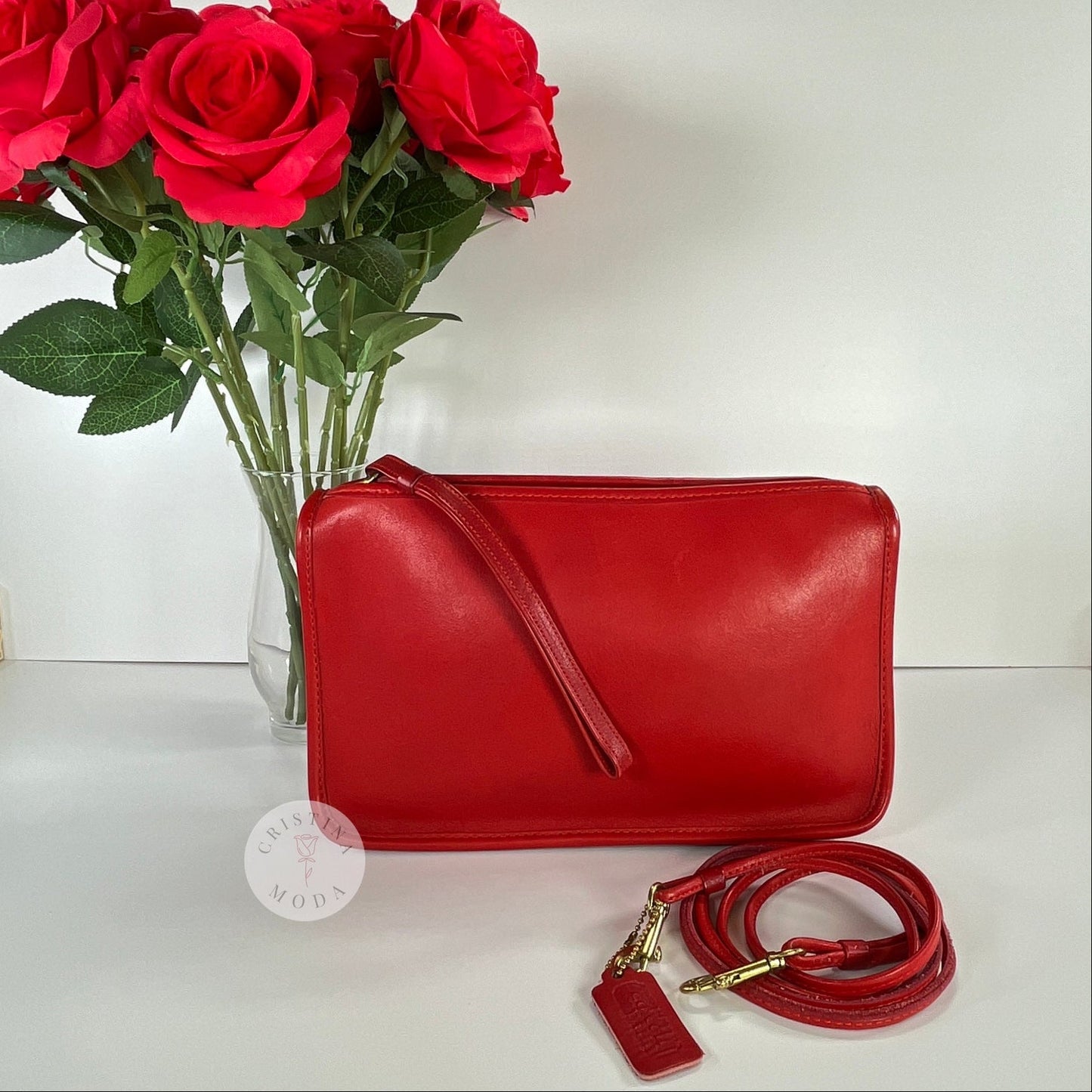 Vintage Coach Zippered Clutch in Red, view of front with vase of roses in background