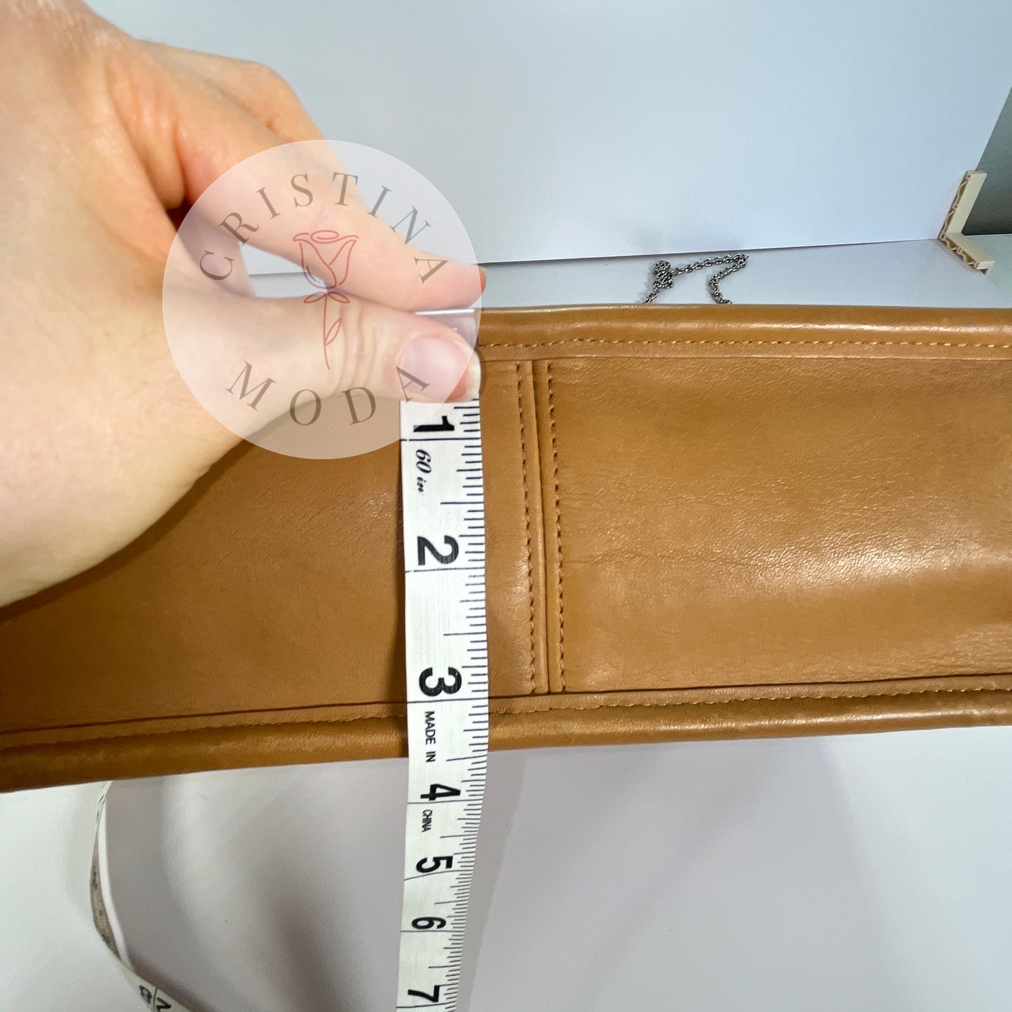photo showing a tape measure measuring the bottom width of the bag- it measures about 3.5 inches