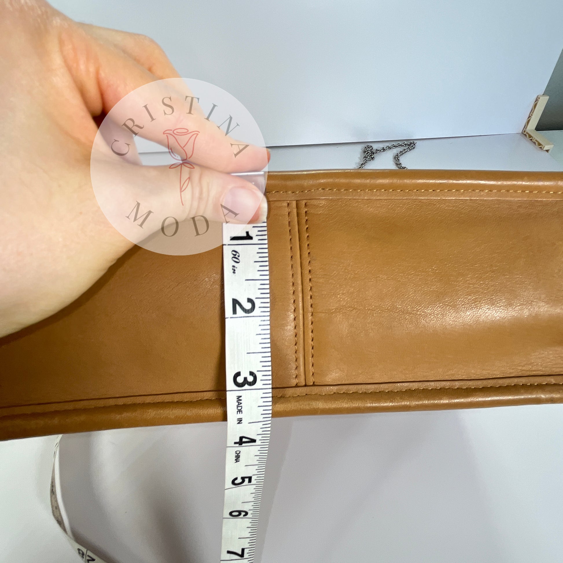 photo showing a tape measure measuring the bottom width of the bag- it measures about 3.5 inches
