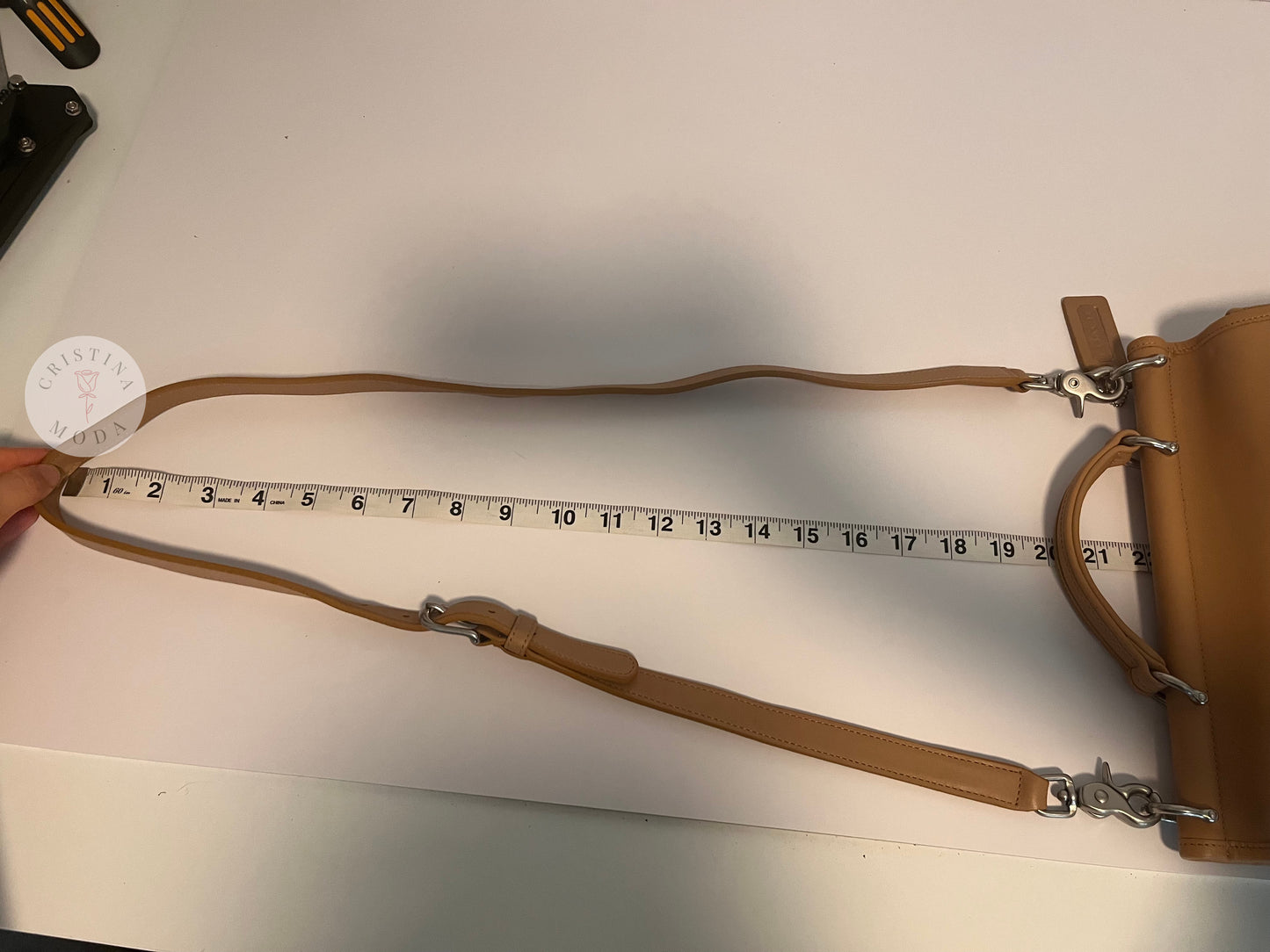 Photo showing the strap drop being measured with measuring tape. The measuring tape shows the drop is approx. about 22 inches. 