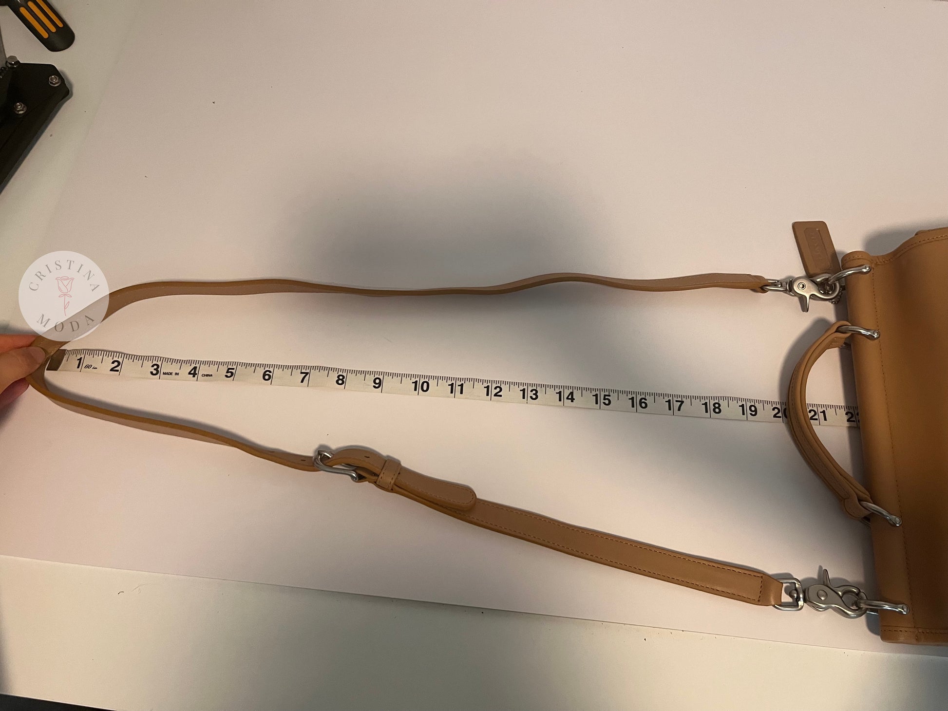 Photo showing the strap drop being measured with measuring tape. The measuring tape shows the drop is approx. about 22 inches. 