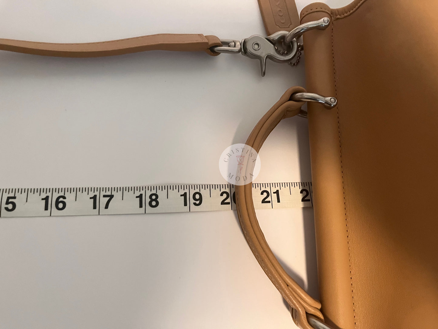 Close up photo showing the strap drop being measured with measuring tape. The measuring tape shows the drop is approx. about 22 inches. 