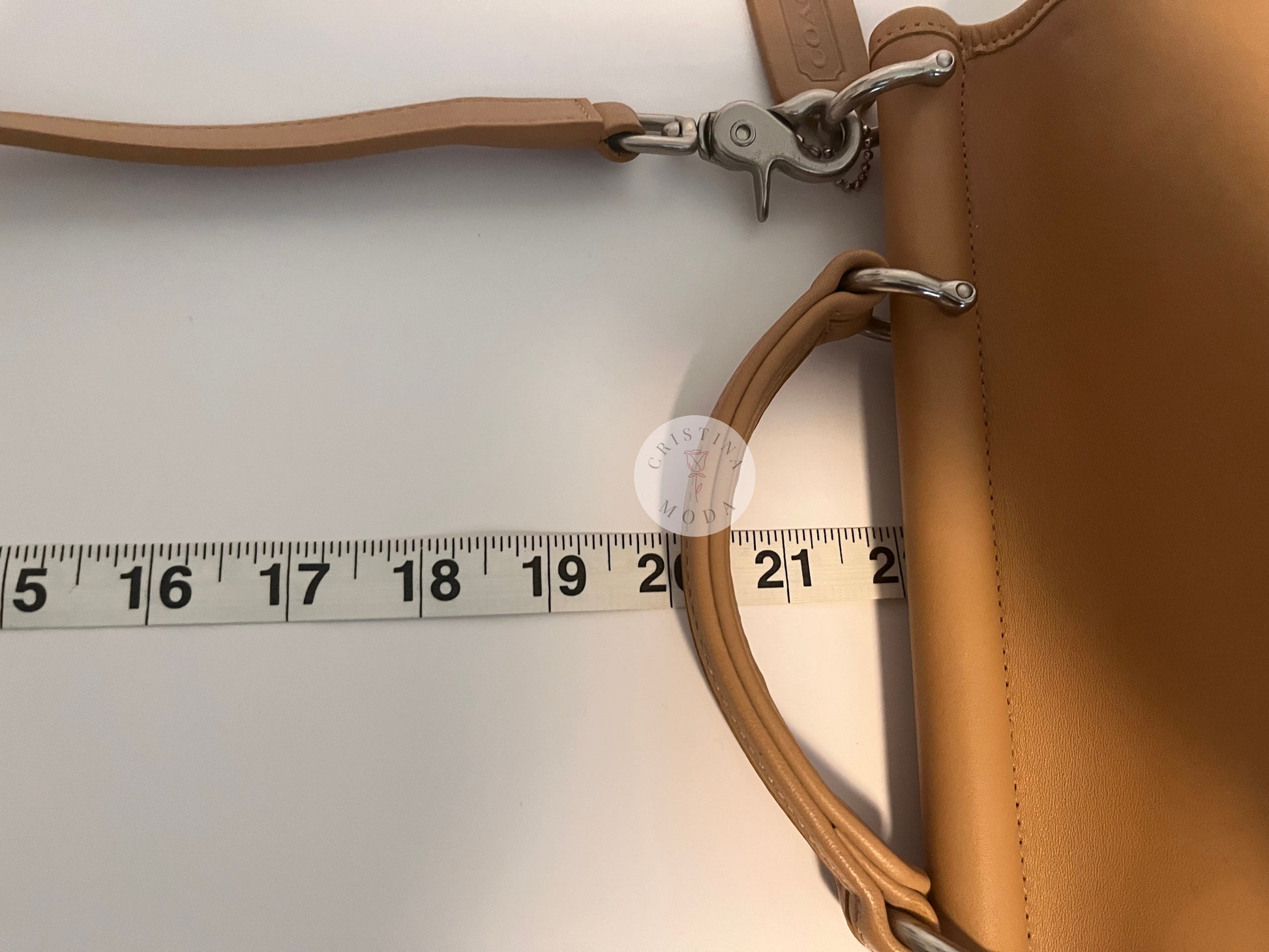 Close up photo showing the strap drop being measured with measuring tape. The measuring tape shows the drop is approx. about 22 inches. 